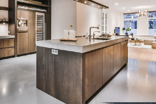 Modern open-concept kitchen with a large wood island, sleek cabinetry, and integrated lighting